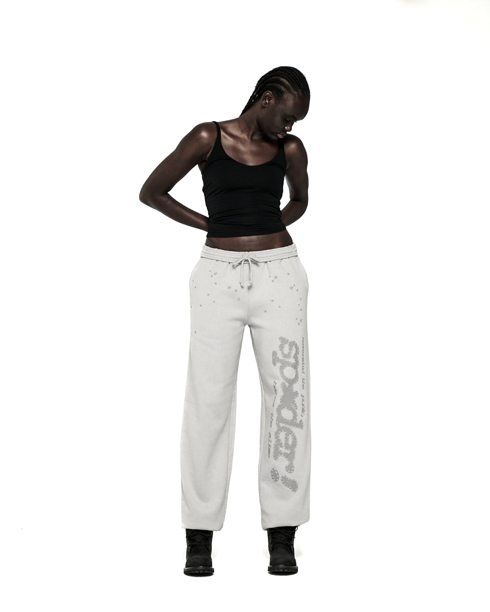 Light grey cotton fleece sweatpants with "SP5DER" text and scattered star print.
