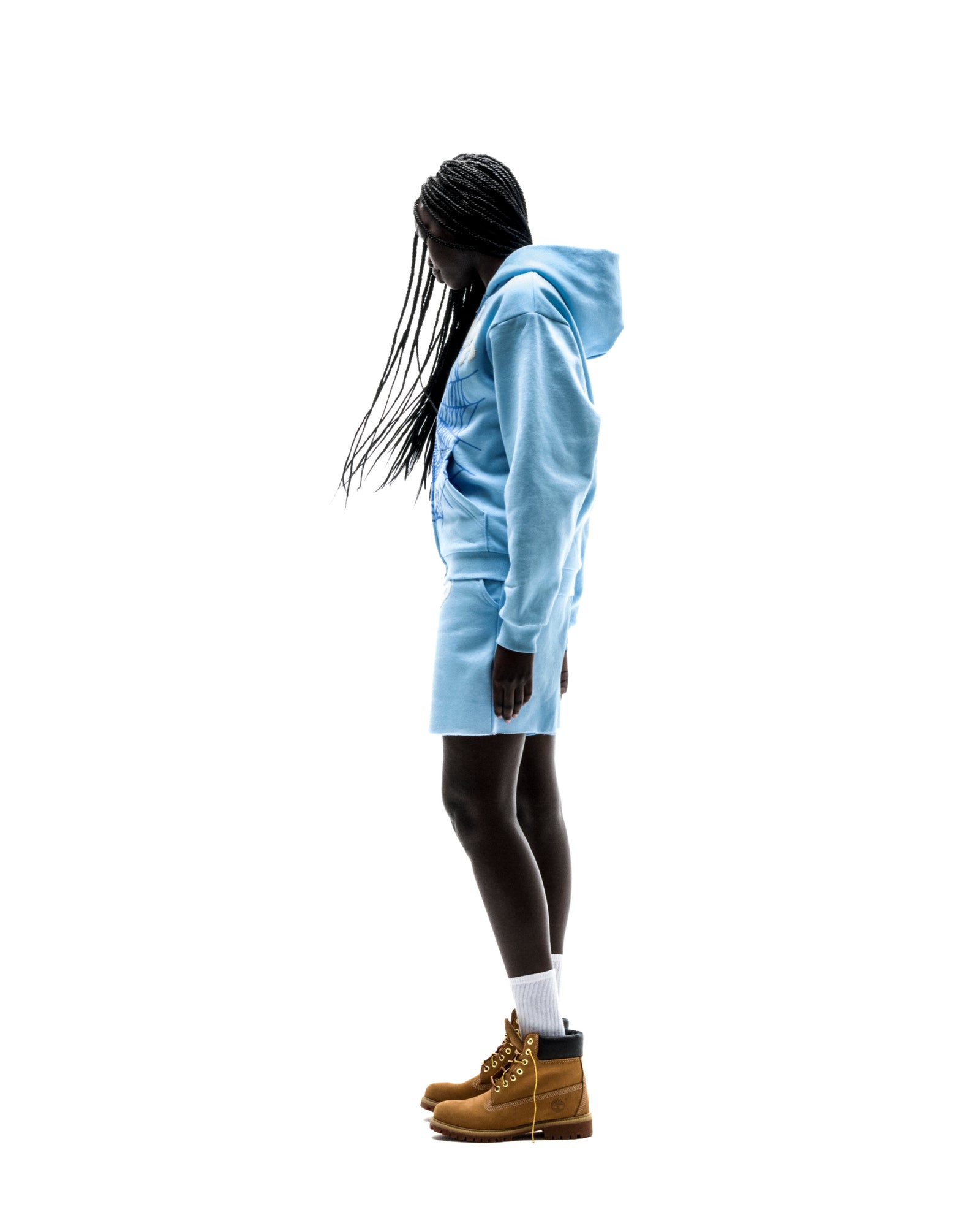 Model in light blue OG WEB ZIP UP hoodie and matching shorts, with brown boots.