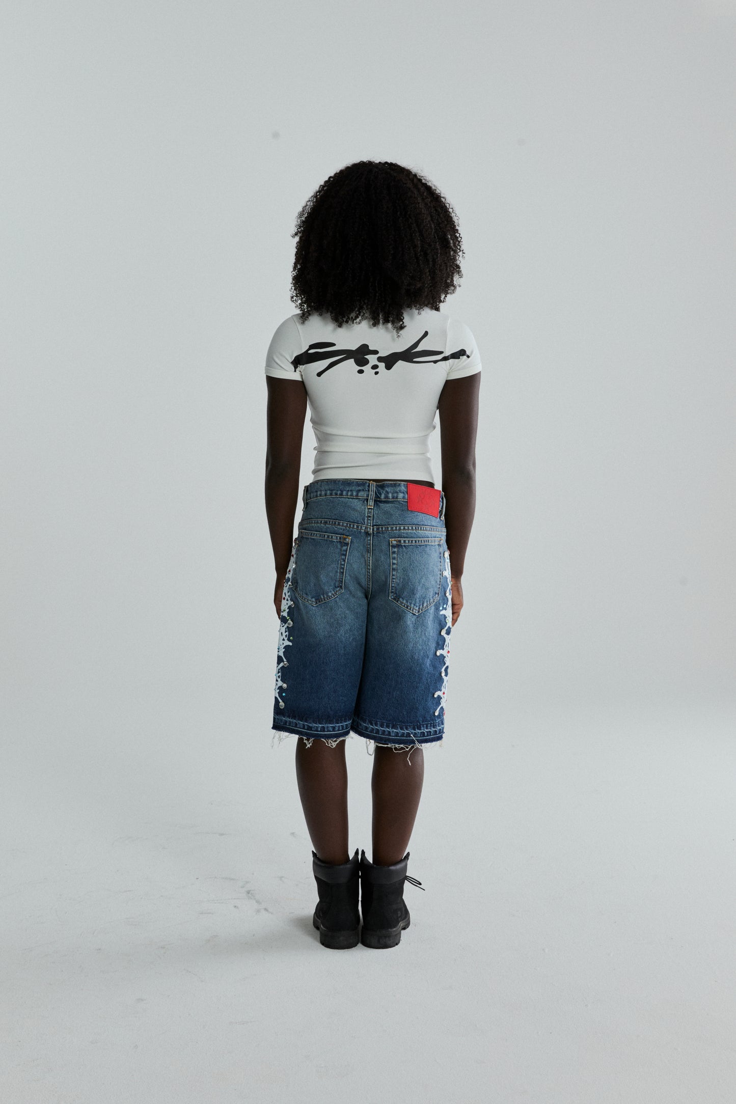 WHITE TM BABY TEE ON MODEL