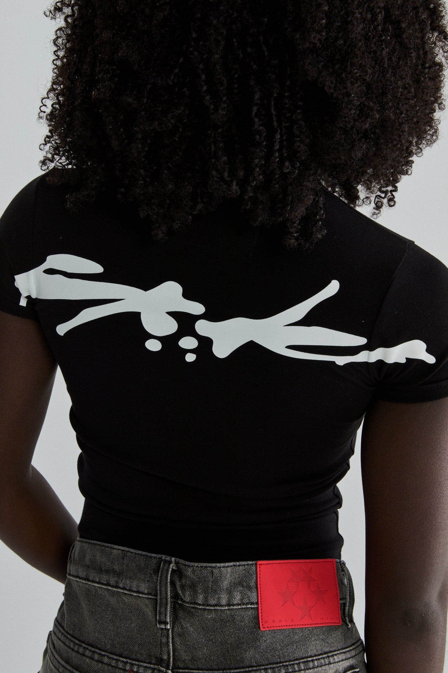 BLACK TM BABY TEE ON MODEL