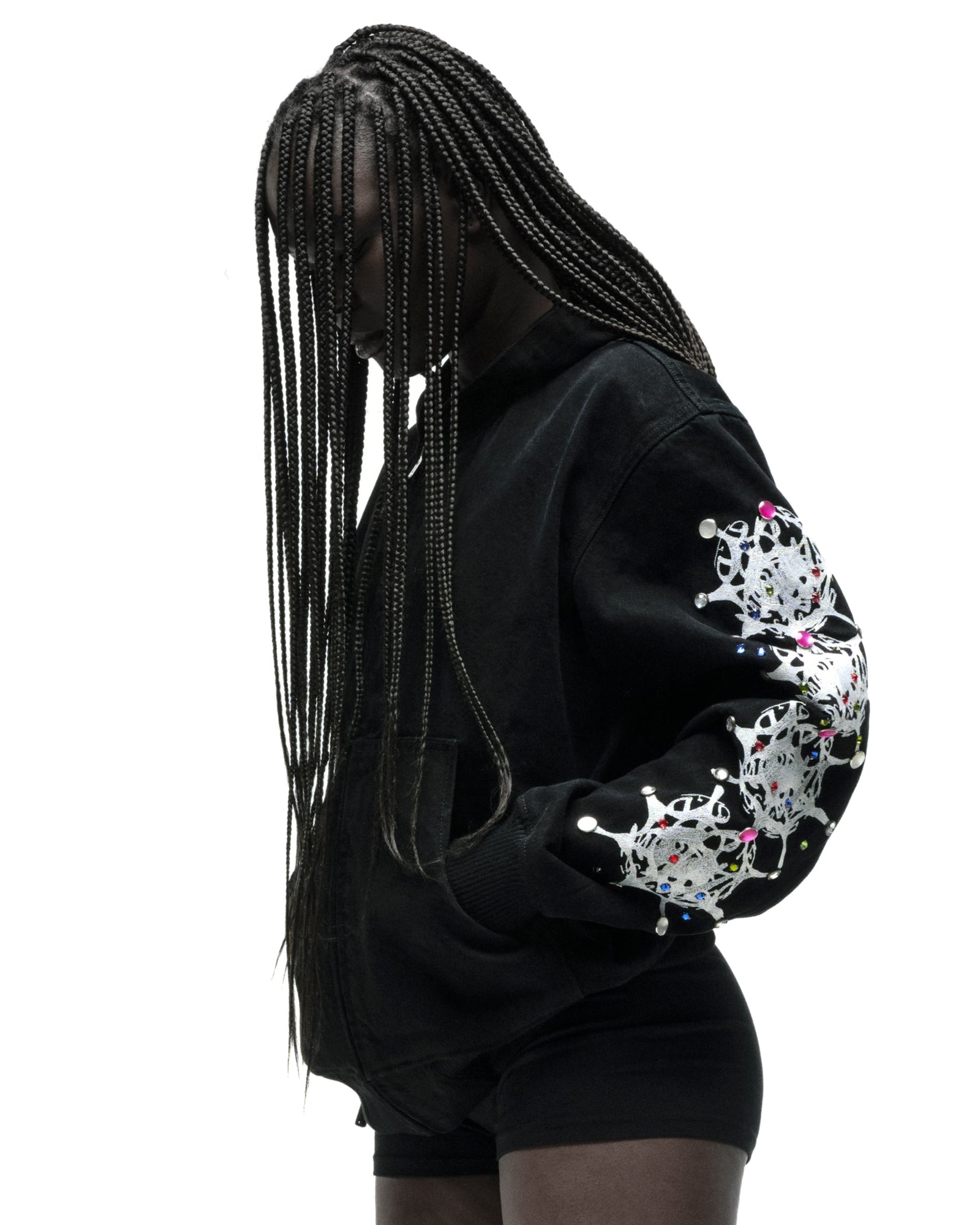 Black cotton canvas hooded jacket with web print and rhinestone sleeves.