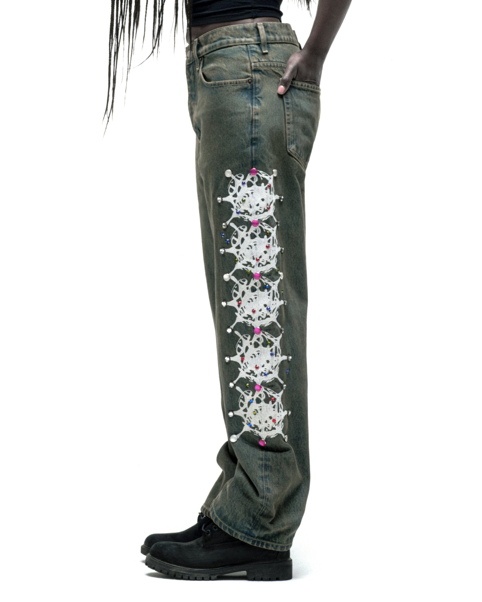 Vintage wash 13oz denim pants with white web print and colorful rhinestone embellishments down the leg.