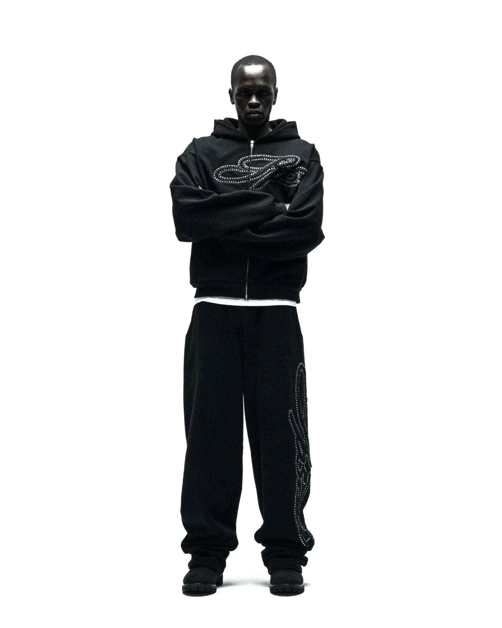 Black 100% cotton wide-leg sweatpants with rhinestone script down the leg, paired with a matching hoodie.
