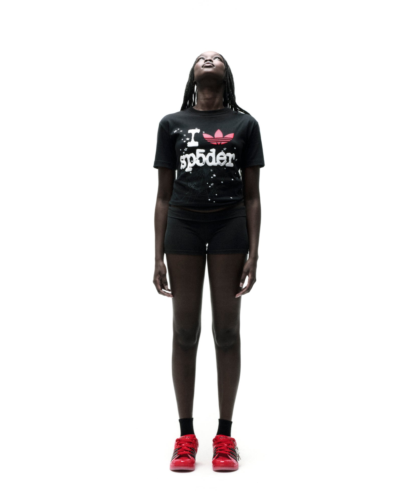 Black Adidas Souvenir Tee with red Trefoil x SP5DER graphic, worn by a model on a white background.