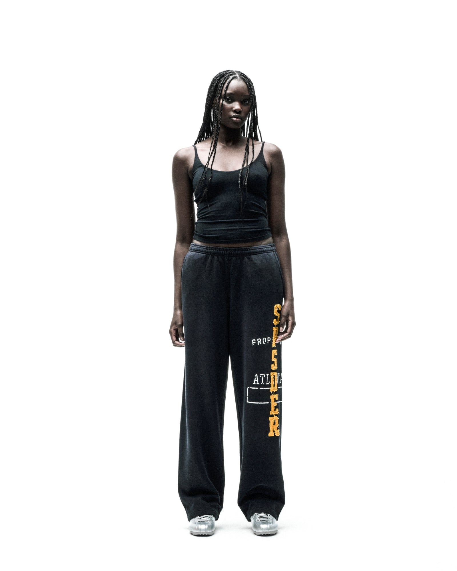 Black ISSUE 404 wide-leg sweatpants with raised chenille-style "SPSDER" lettering and frayed edges.