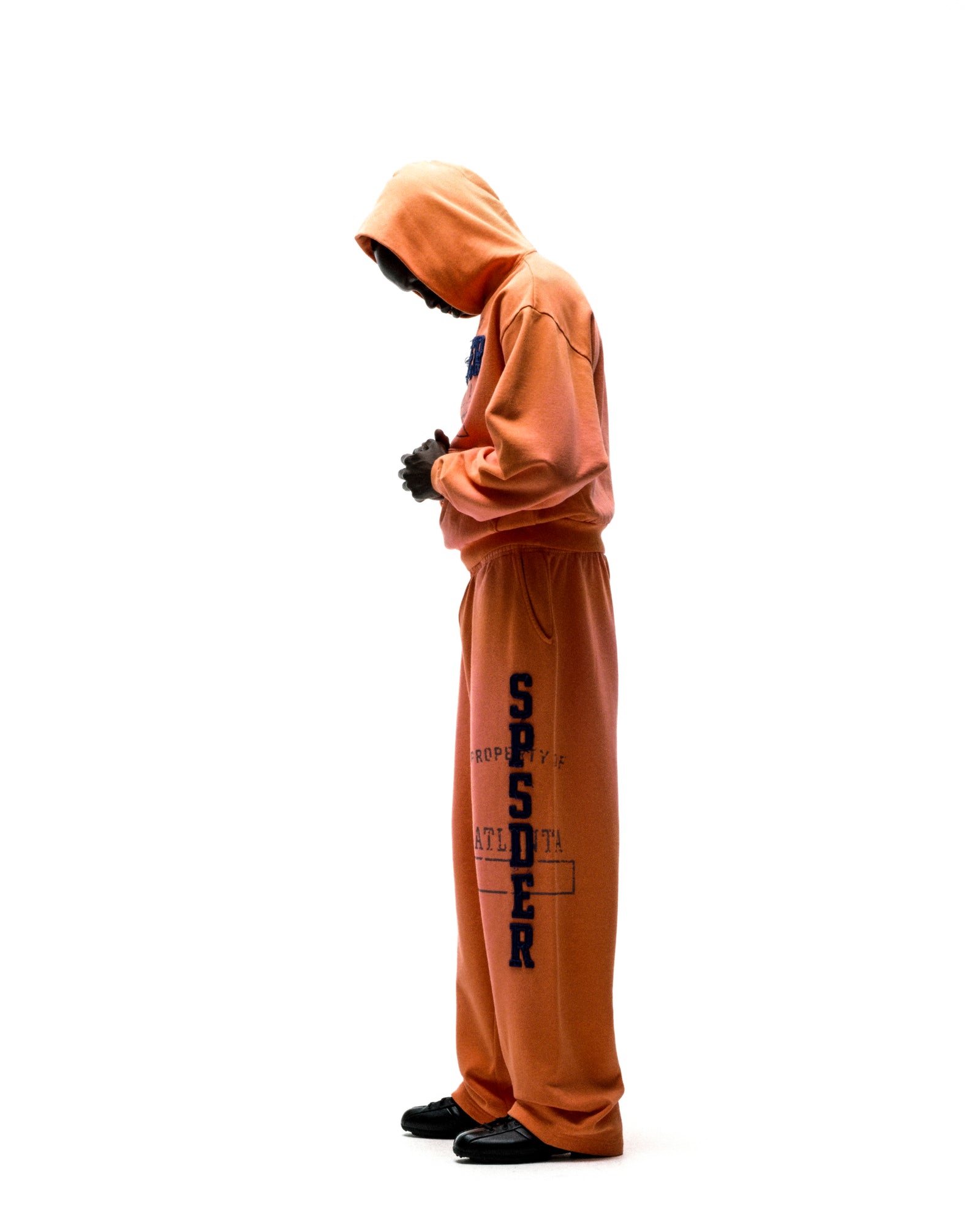 Orange cotton fleece hoodie and sweatpants with raised chenille "SPSDER" lettering and faded graphic print.