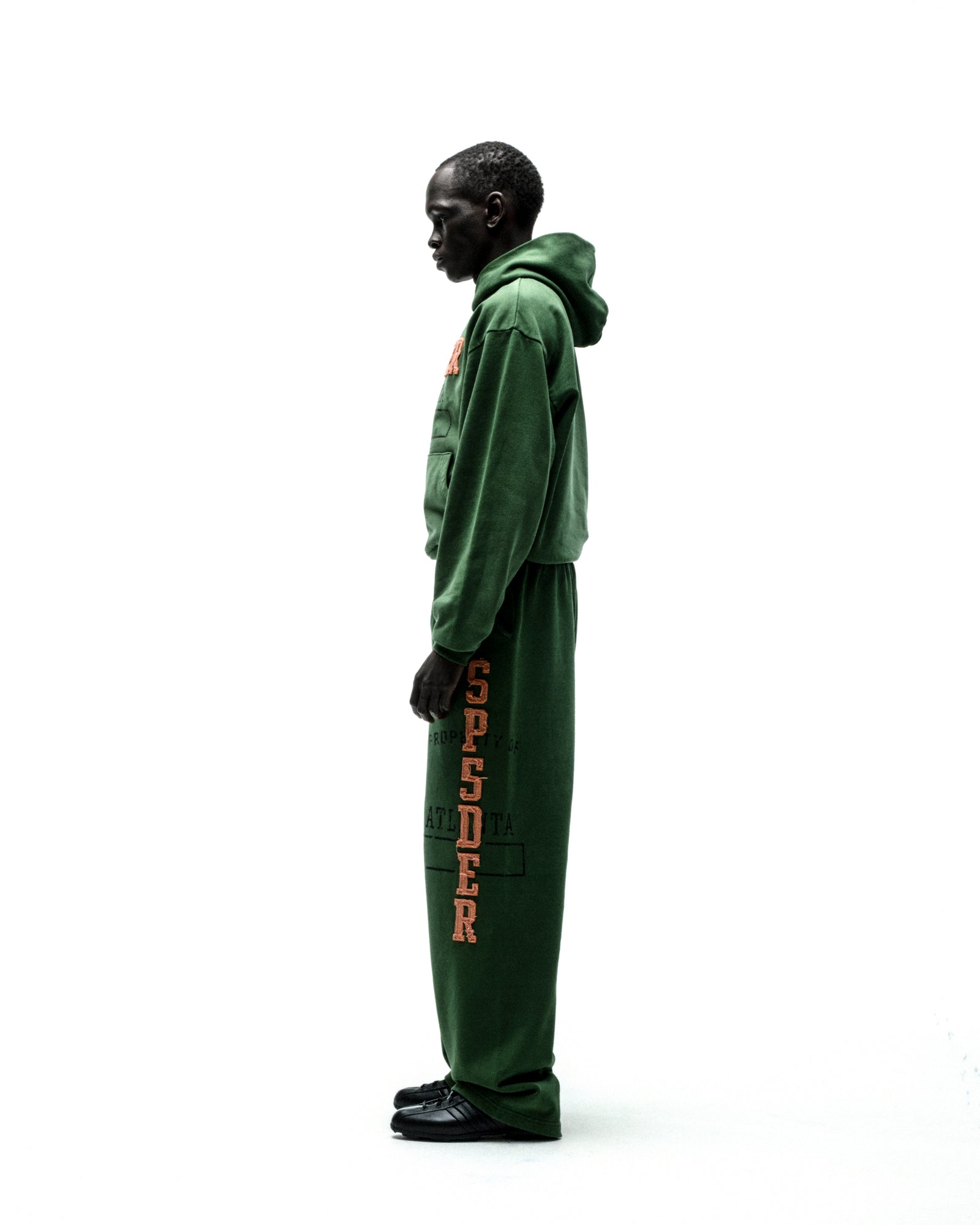 Green cotton fleece hoodie and sweatpants with orange "SP5DER" chenille lettering.