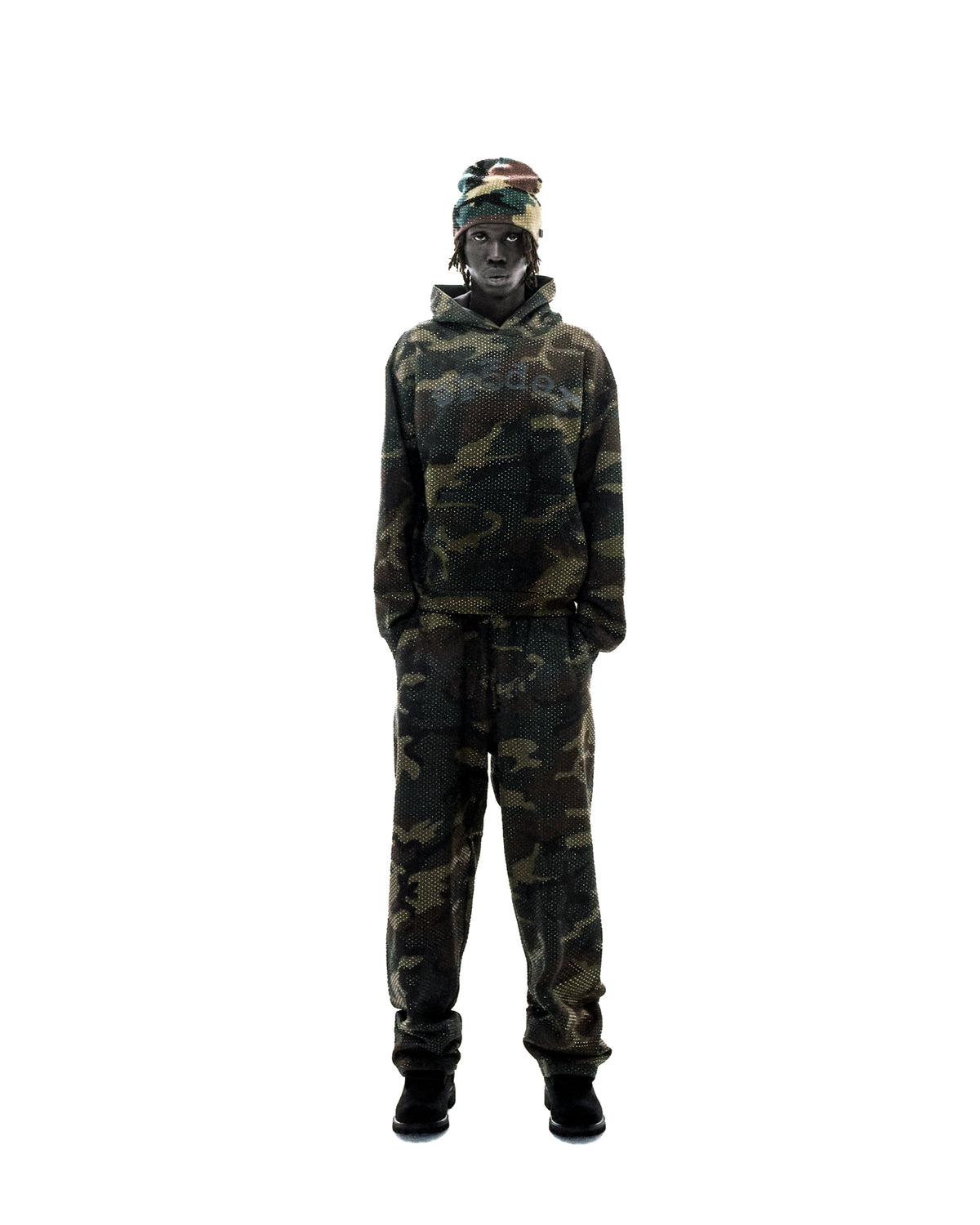 Model wearing a matching camouflage mesh hoodie and joggers with a coordinating beanie against a white background.
