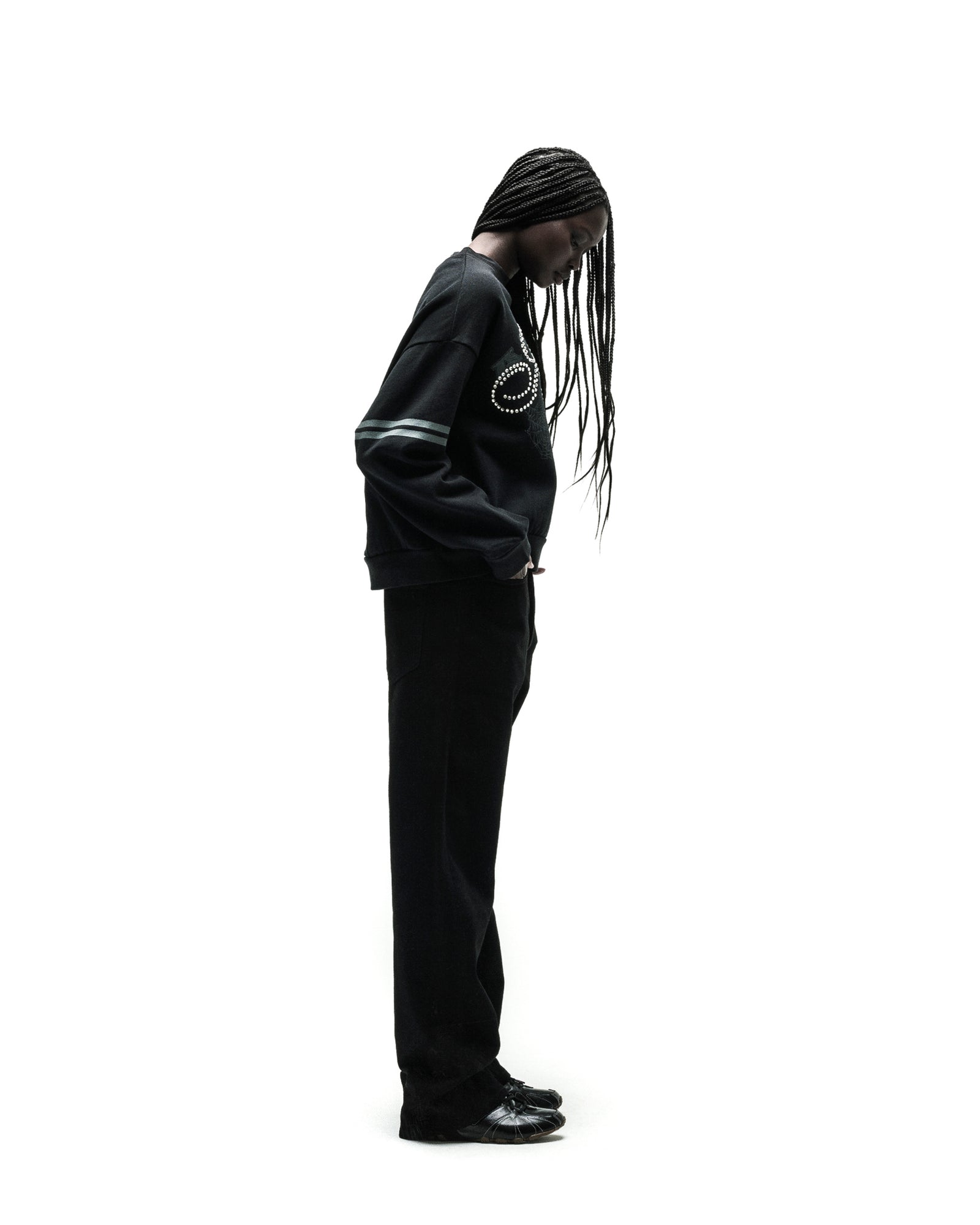 ARANEA CREWNECK: Black oversized sweatshirt with silver studded spiral design and striped sleeves.