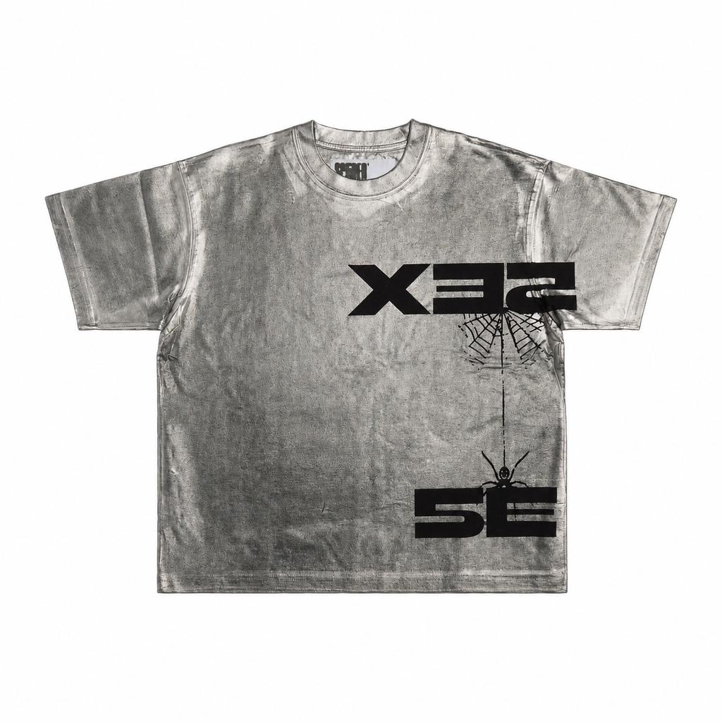 Metallic silver 100% cotton tee featuring a black graphic print of a spider and web with bold logo text.