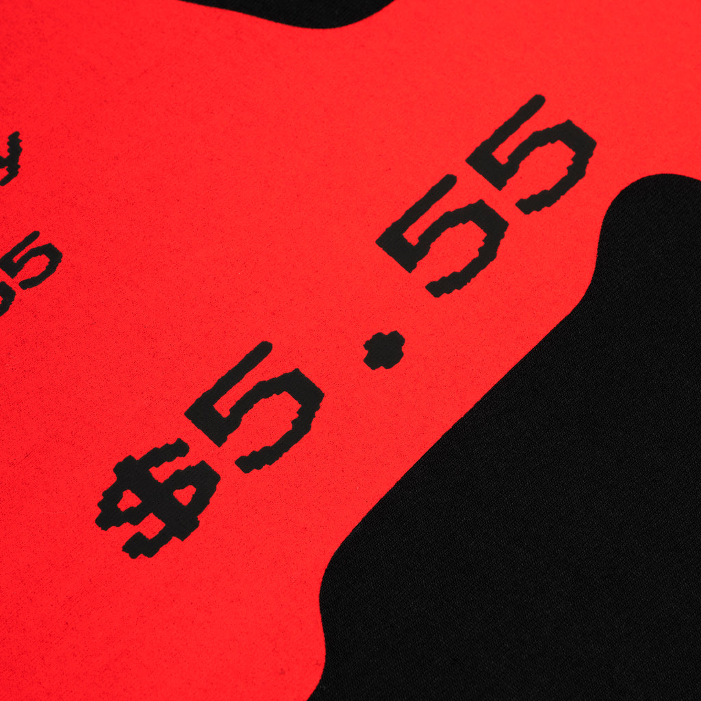 Close-up of a black cotton tee with a bold red graphic print featuring "$5.55" in black text.
