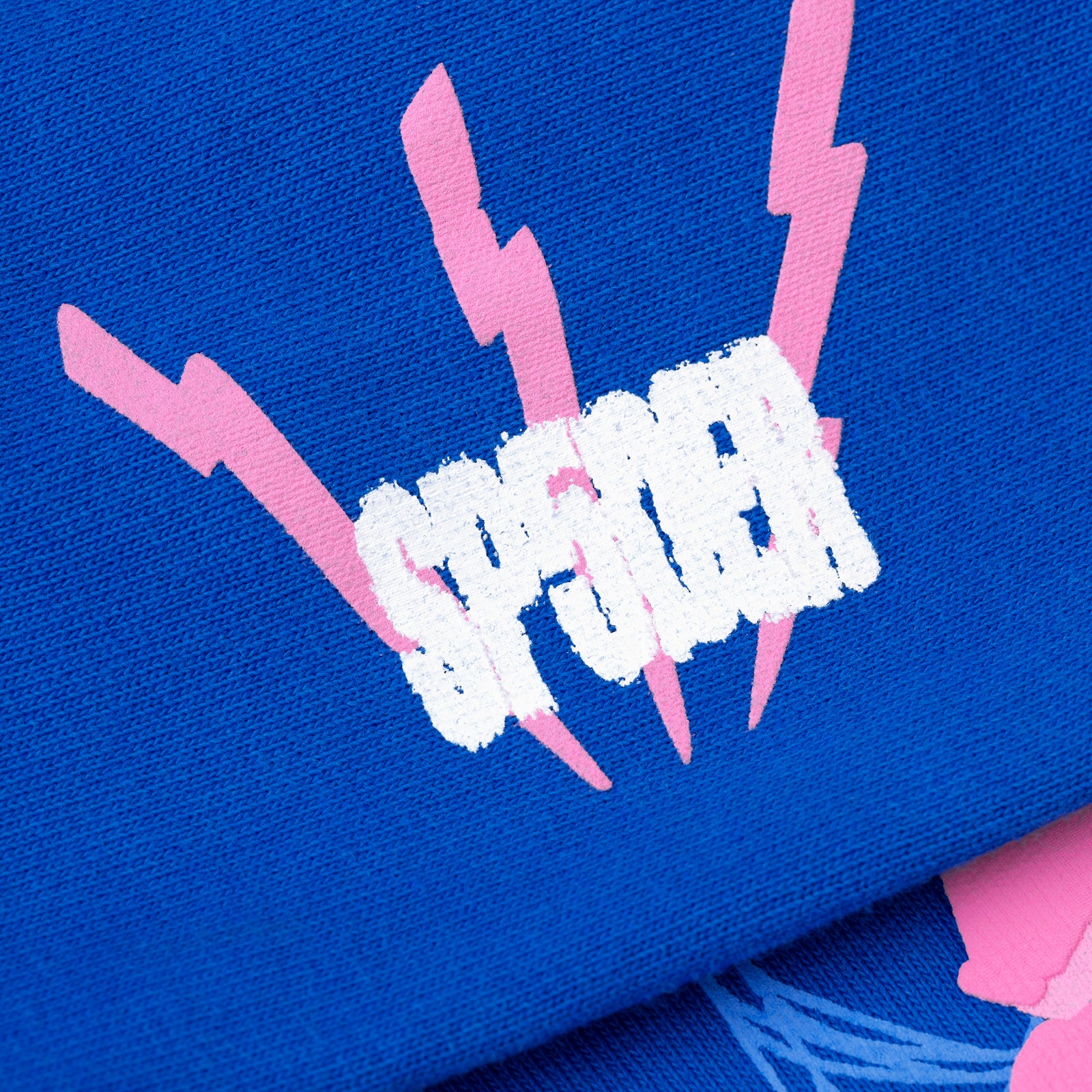 Blue fleece hoodie with white "SP5DER" puff print and pink lightning bolts.