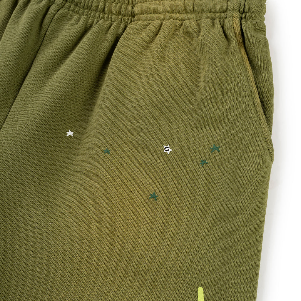 Olive green HEAVY WEB SWEATPANT with SP5DER web graphic and scattered star print.