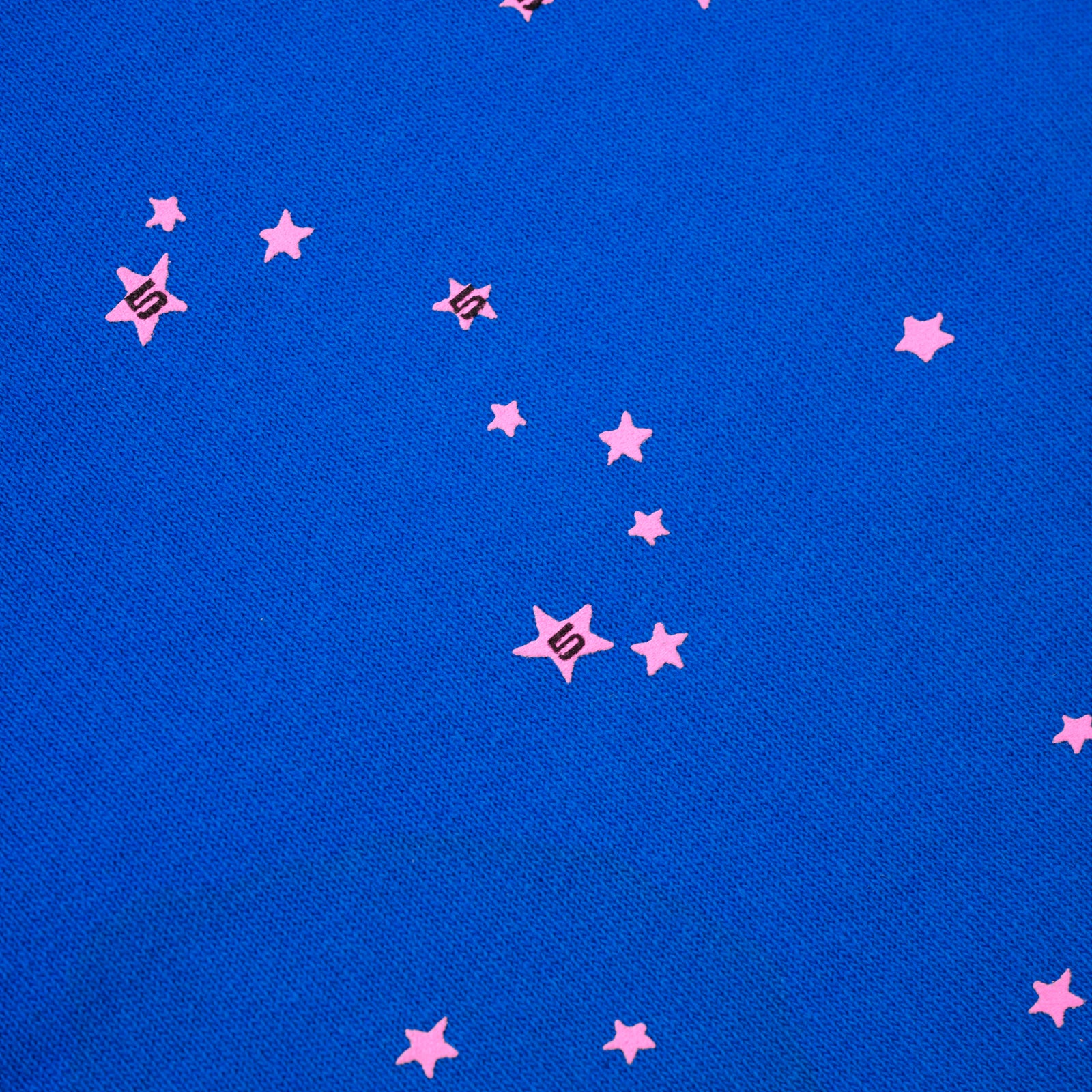 Blue cotton fleece sweatpant with scattered pink star print.
