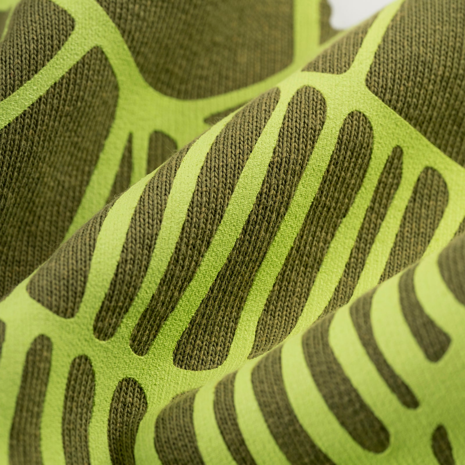 Close-up of olive green cotton fleece sweatpants with bright green SP5DER web graphic.