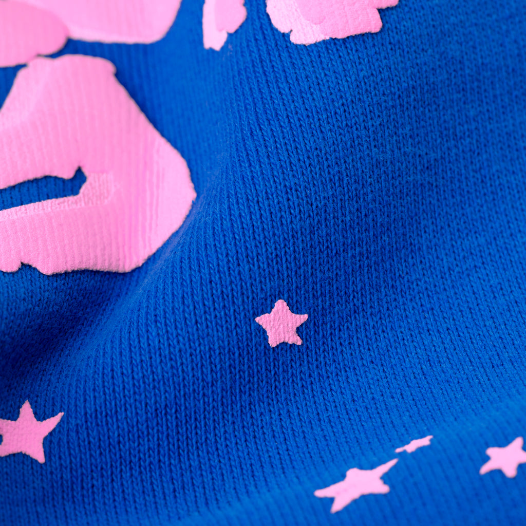 Blue cotton fleece sweatpant with pink puff print '555' angel numbers and scattered stars.
