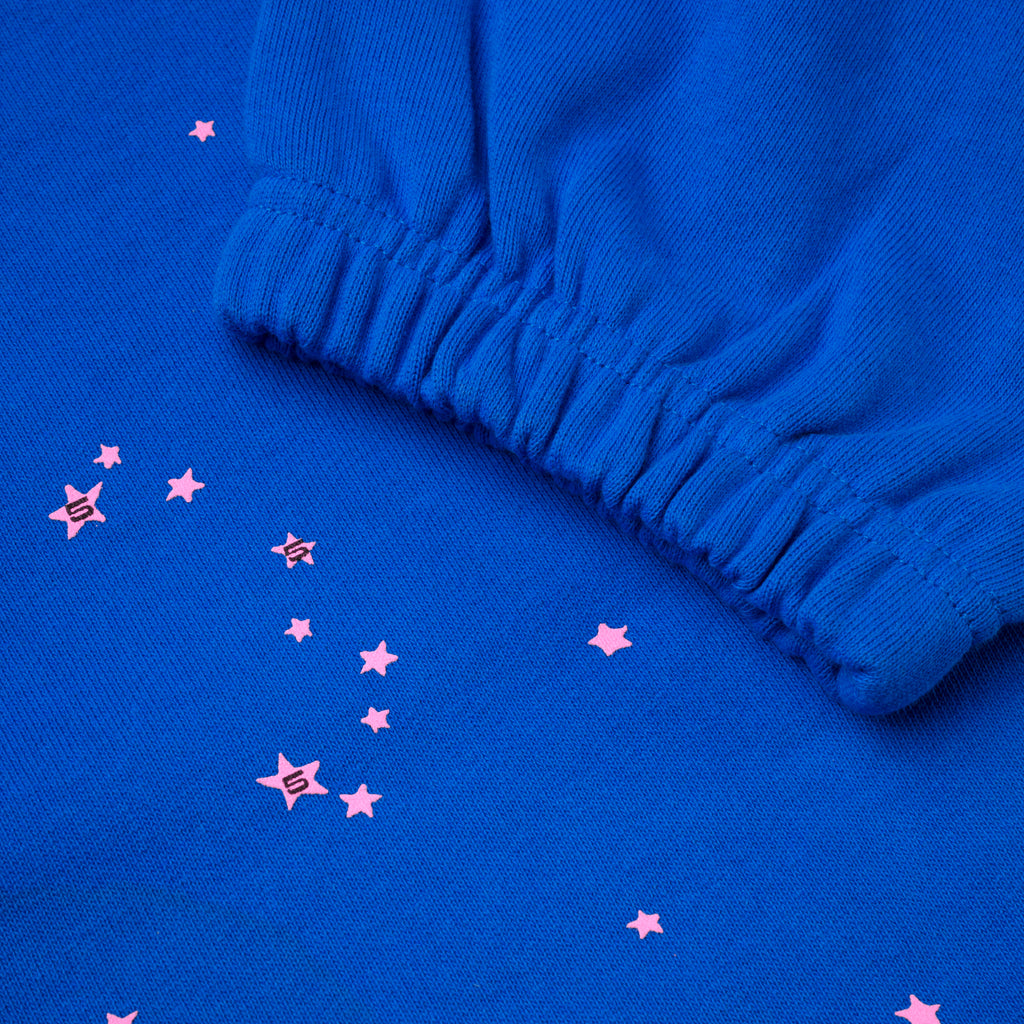 Blue cotton fleece sweatpant with pink scattered stars and elasticized cuff.
