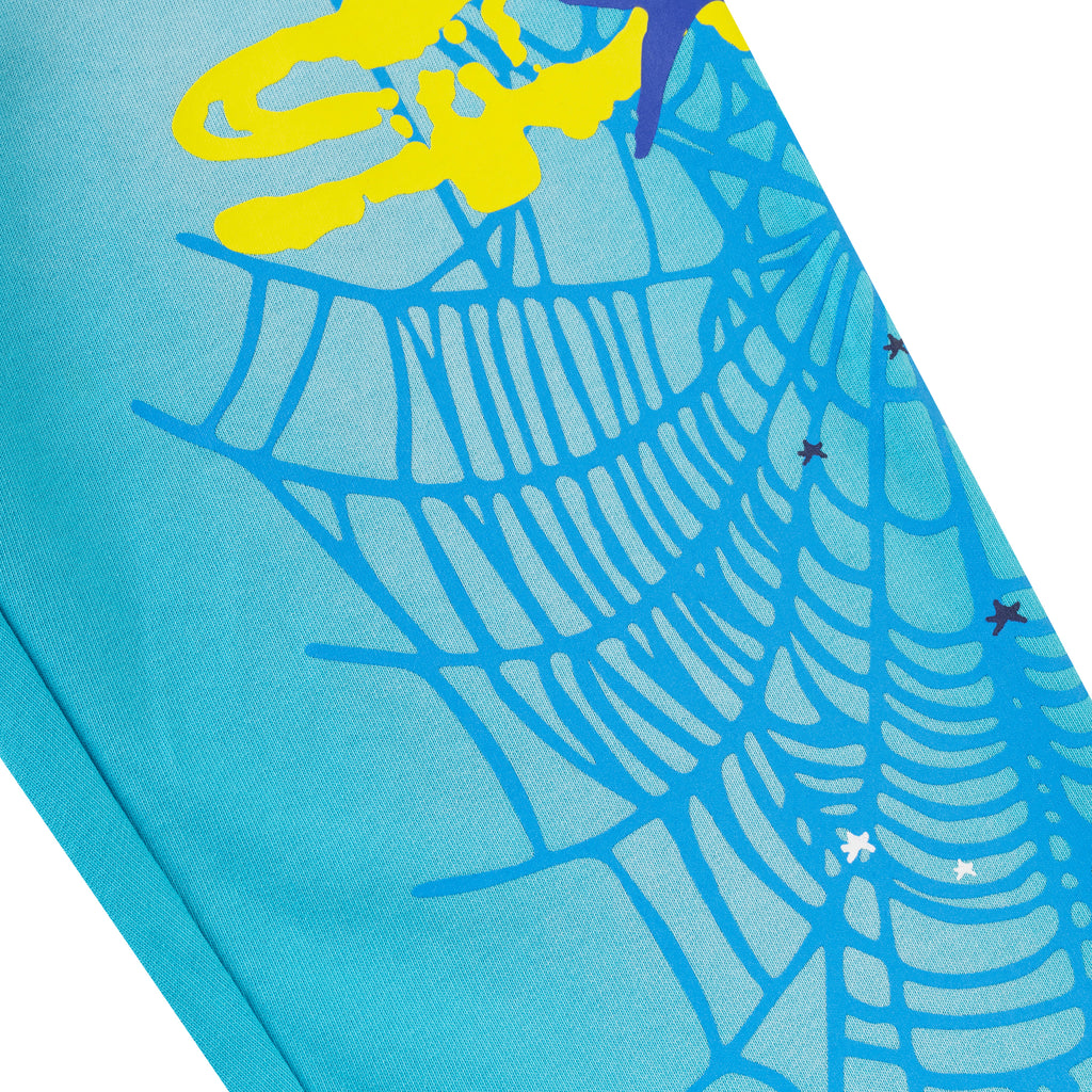 Blue cotton fleece sweatpant with SP5DER web graphic and scattered star print.