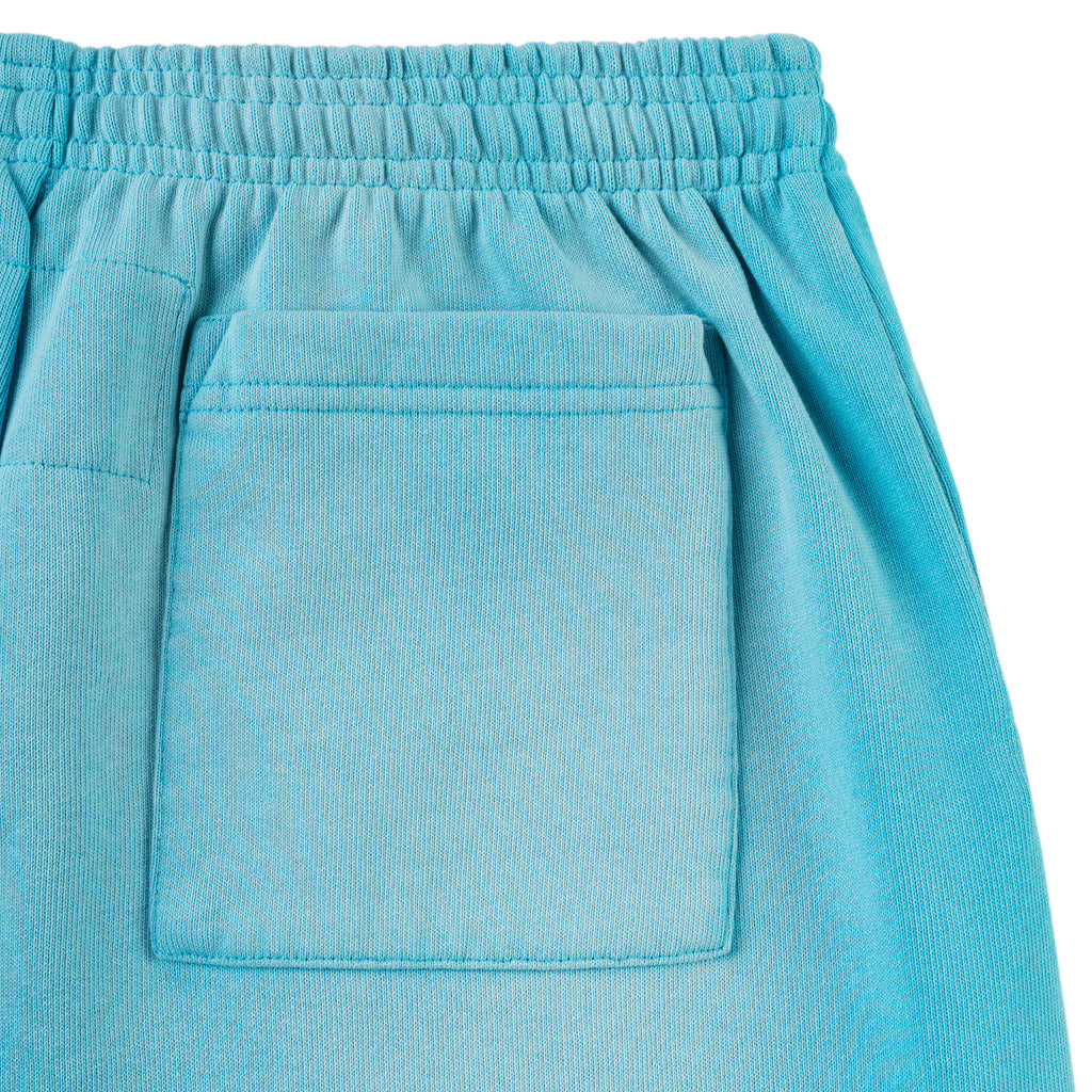 Close-up of a light blue cotton fleece sweatpant with an elasticized waistband and a back patch pocket.
