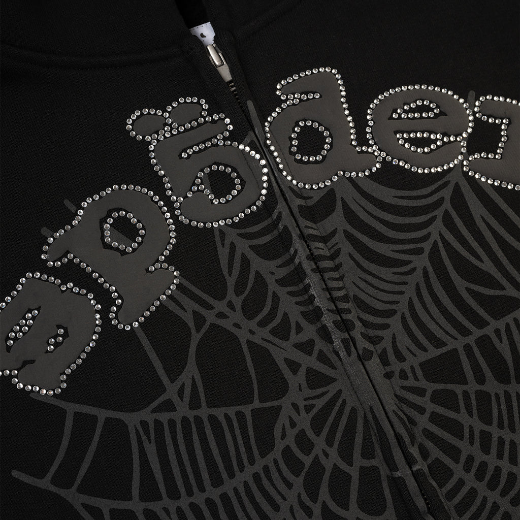 Black 13oz cotton fleece zip-up with rhinestone "OG WEB" text and spiderweb graphic.