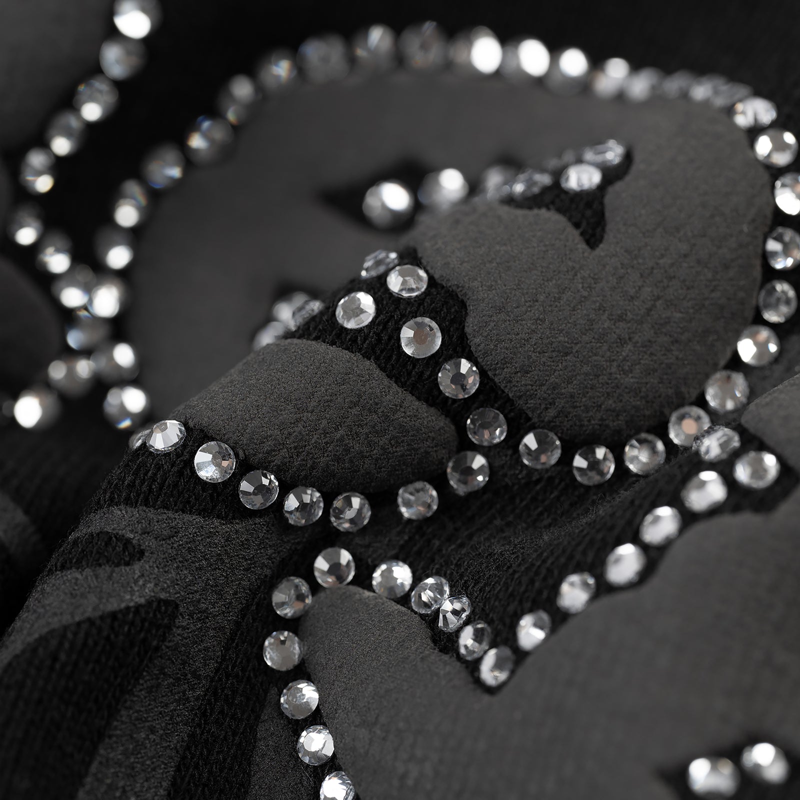 Close-up of black 13oz cotton fleece OG WEB V2 Rhinestone Zip Up with rhinestone border detail.