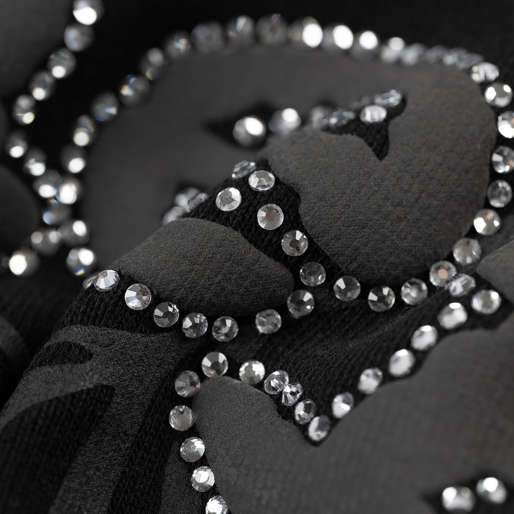 Close-up of black 13oz cotton fleece OG WEB V2 Rhinestone Zip Up with rhinestone border detail.