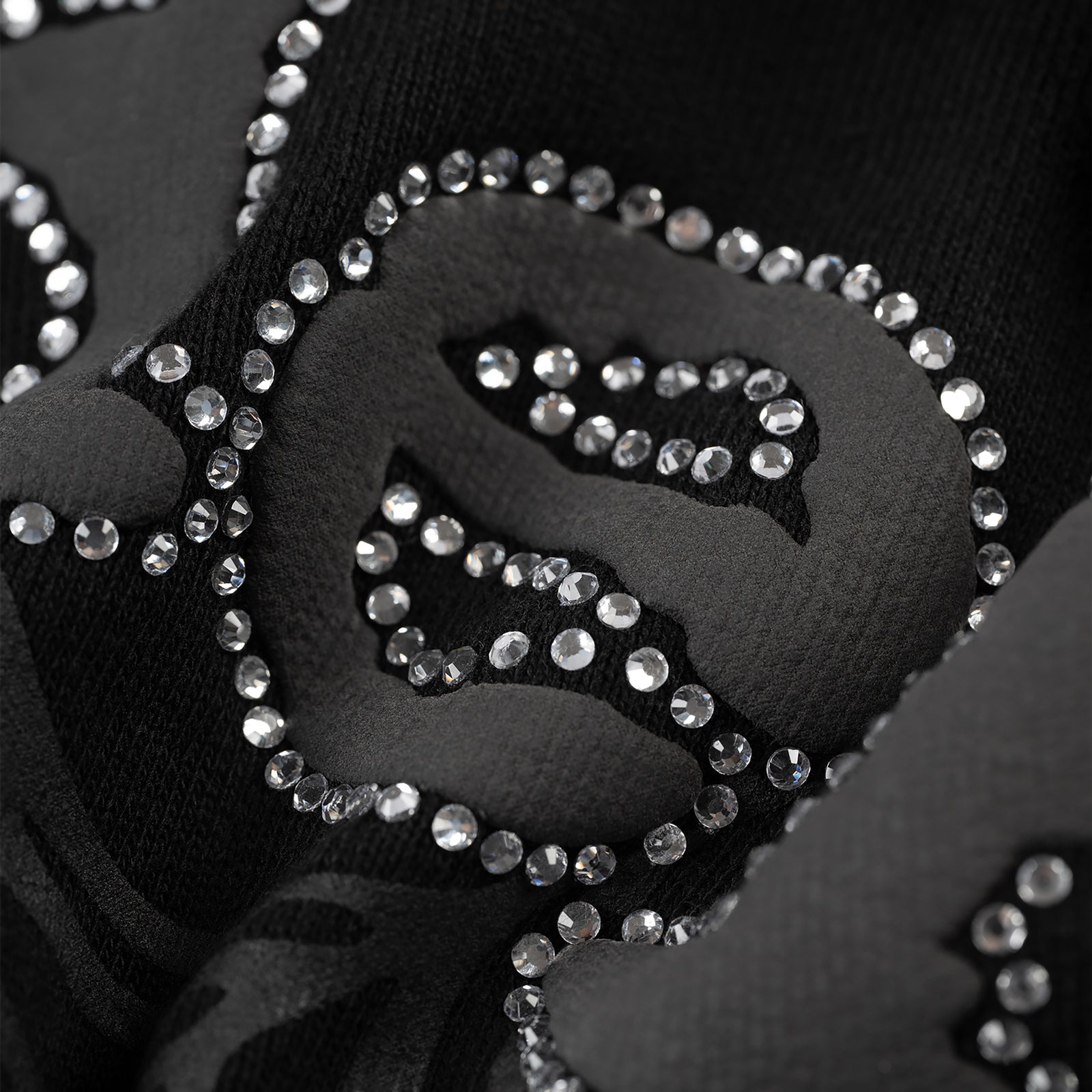 Black cotton fleece zip-up with rhinestone border detail.