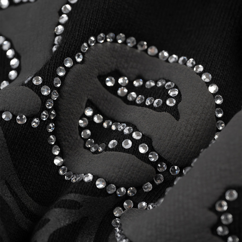 Black cotton fleece zip-up with rhinestone border detail.