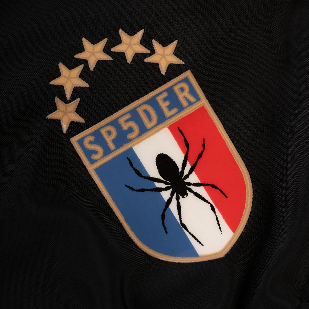 Black stretch nylon bikini with SP5DER crest graphic featuring a spider and stars.
