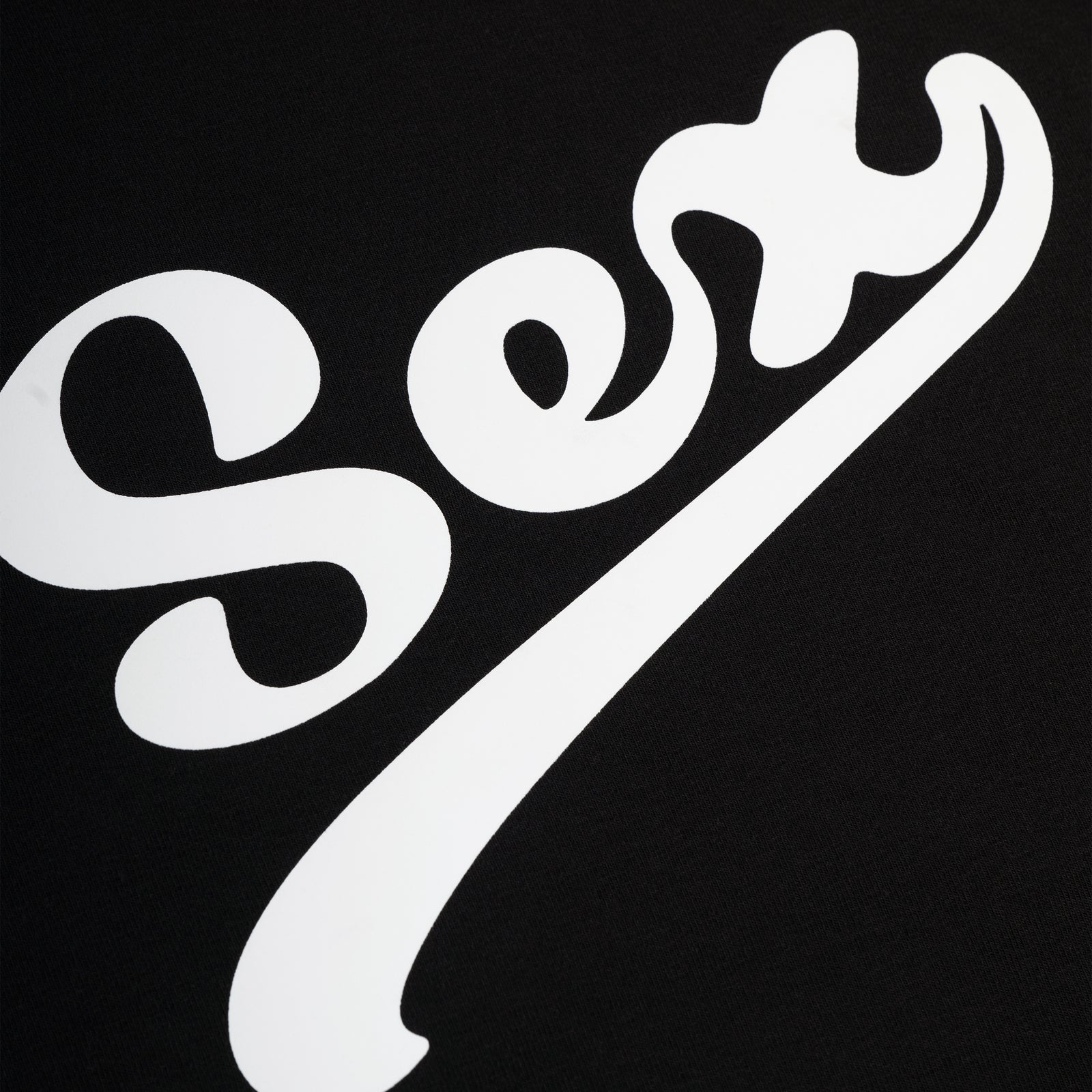 Black cotton/spandex cropped tee with "Sex" graphic print in white script.