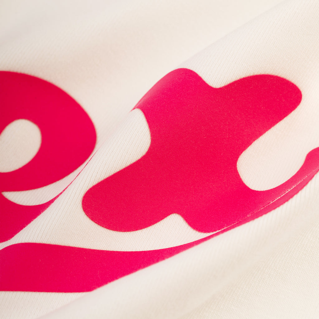 Cropped SEX BABY TEE in cotton/spandex with a vibrant pink graphic print on a cream background.