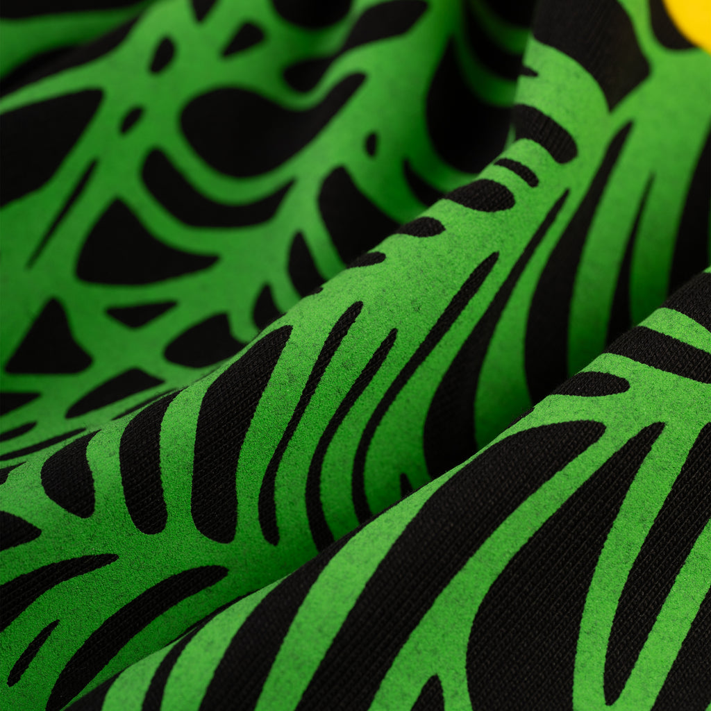 Close-up of a black cotton OG WEB V2 TEE with vibrant green puff print, showing fabric texture and design.