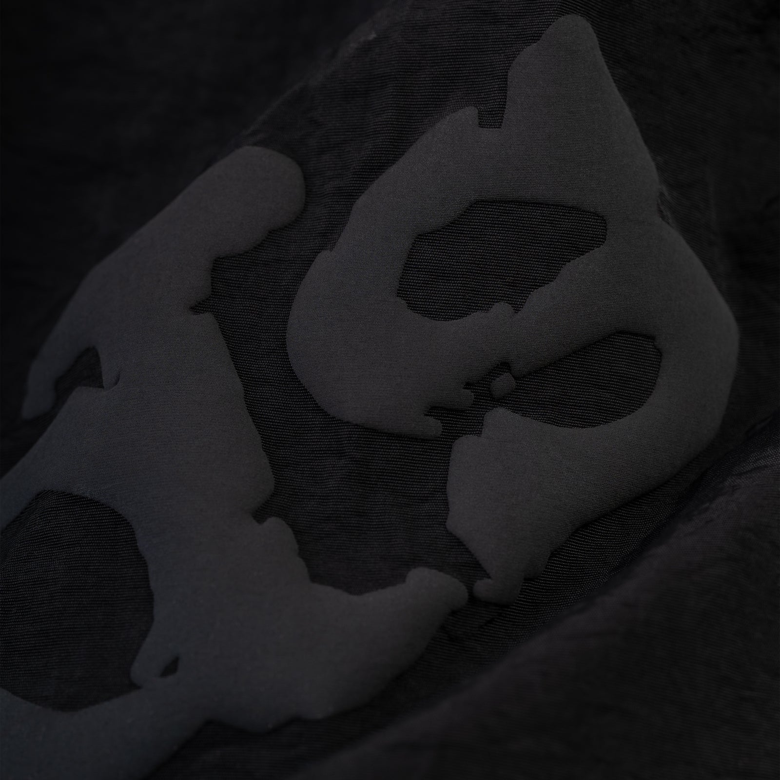 Close-up of black OG WEB Double Layer Short with subtle "OG SP5DER" text and star print.