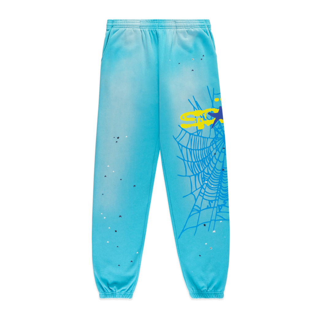 Light blue HEAVY WEB SWEATPANT with yellow SP5DER web graphic and scattered star print.