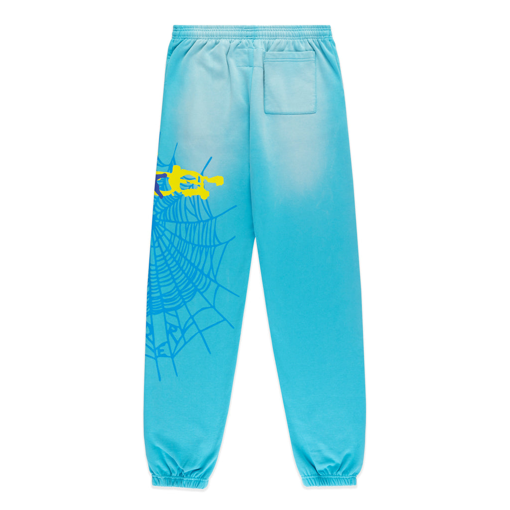 Blue cotton fleece sweatpants with yellow SP5DER web graphic and scattered stars on the leg.