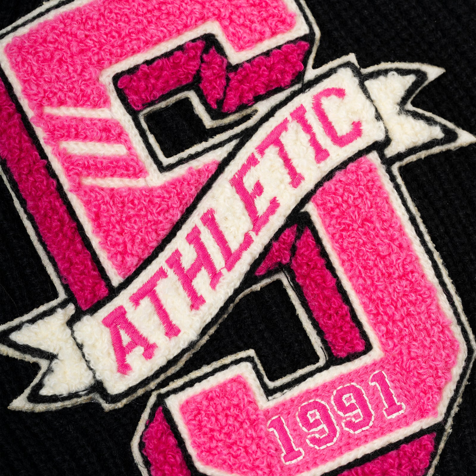 Black knit beanie with a pink chenille '5' patch and an 'ATHLETIC' banner.
