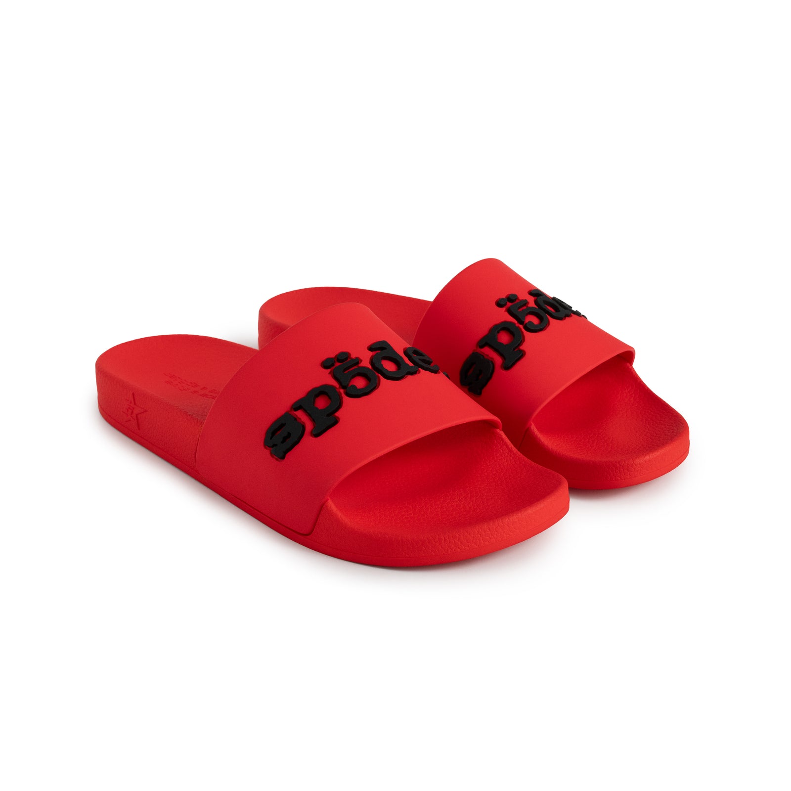 Red rubber Enzo slides with black bonded logo at vamp, molded footbed, and web-design treaded sole.