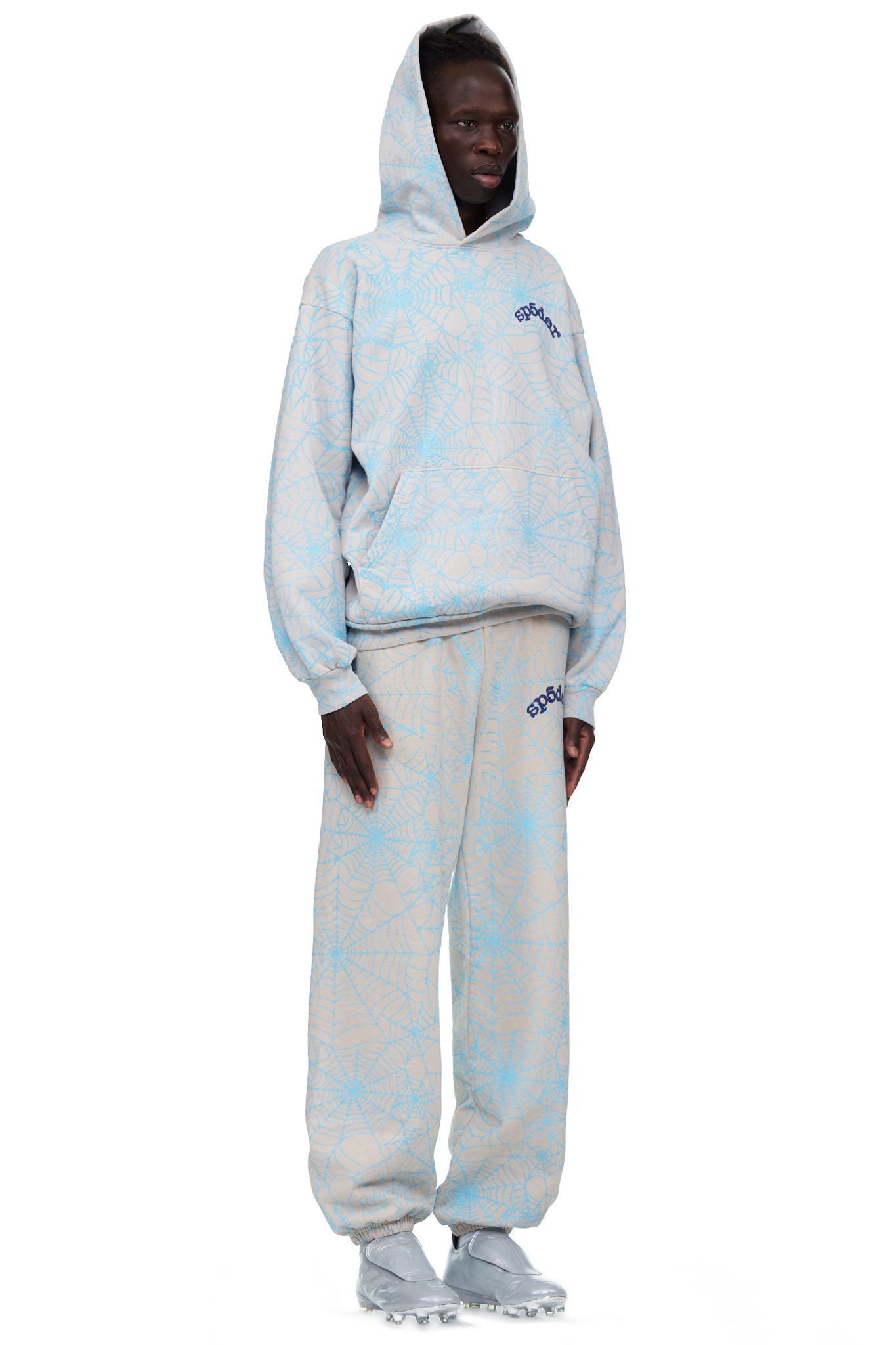 Light grey fleece sweatpant with all-over blue cracked web print and "SP5DER" text.