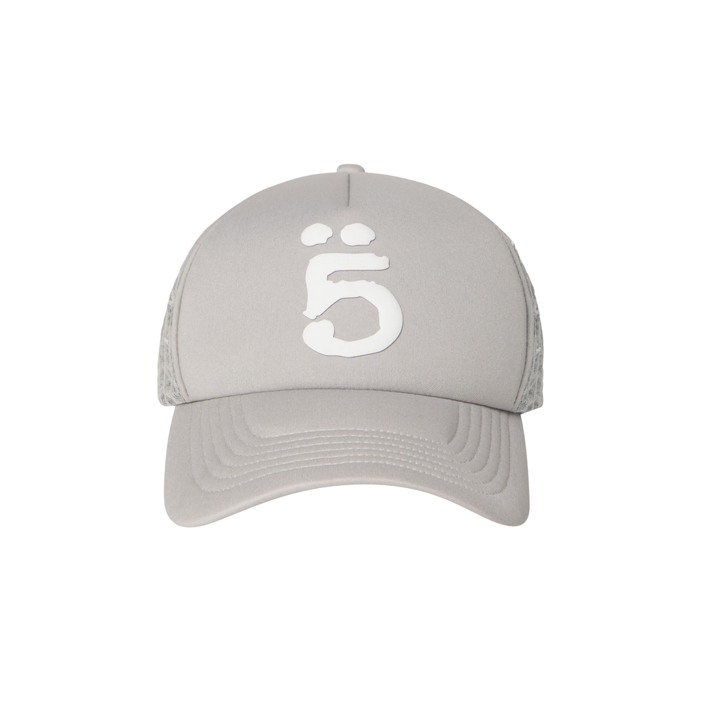 Grey trucker hat with white puff print logo, curved brim, and embroidered web mesh side panels.