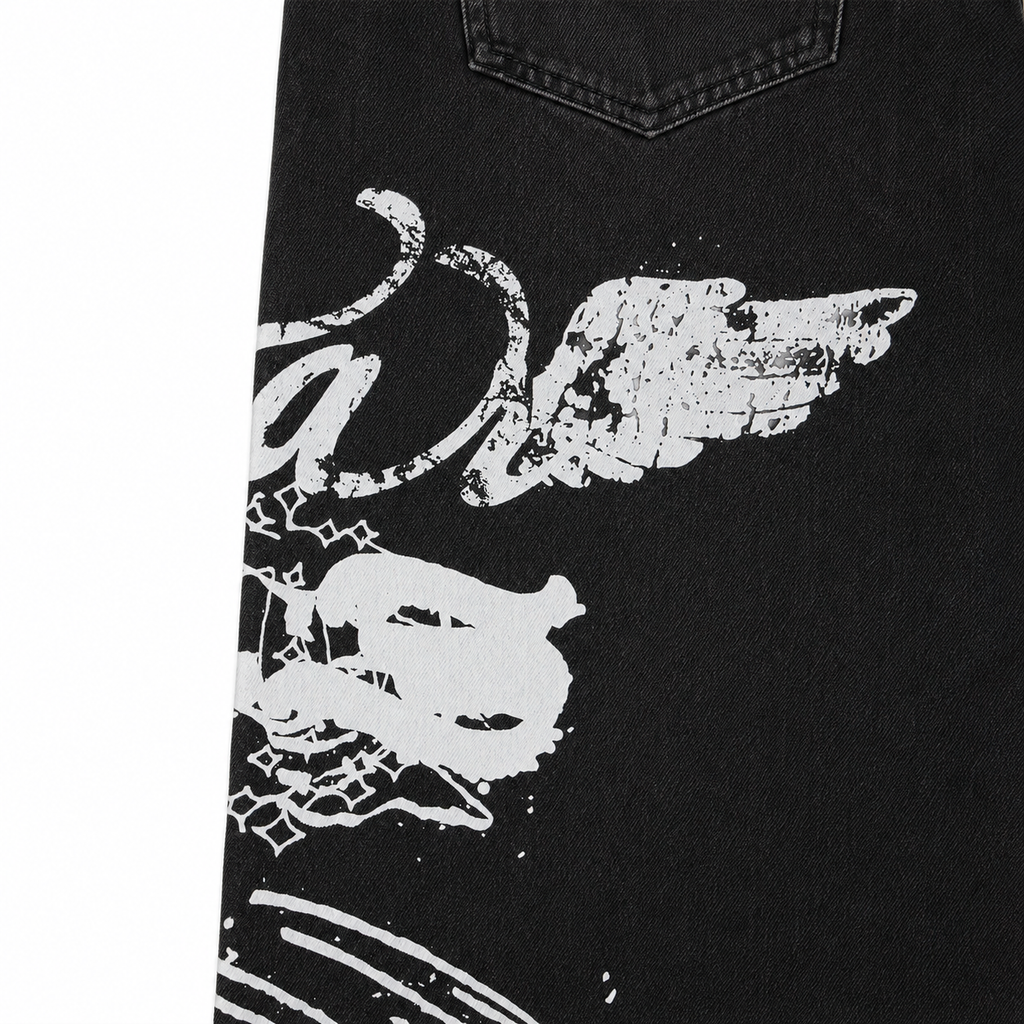 Black denim jeans featuring a white distressed graphic print on the leg and classic five-pocket styling.