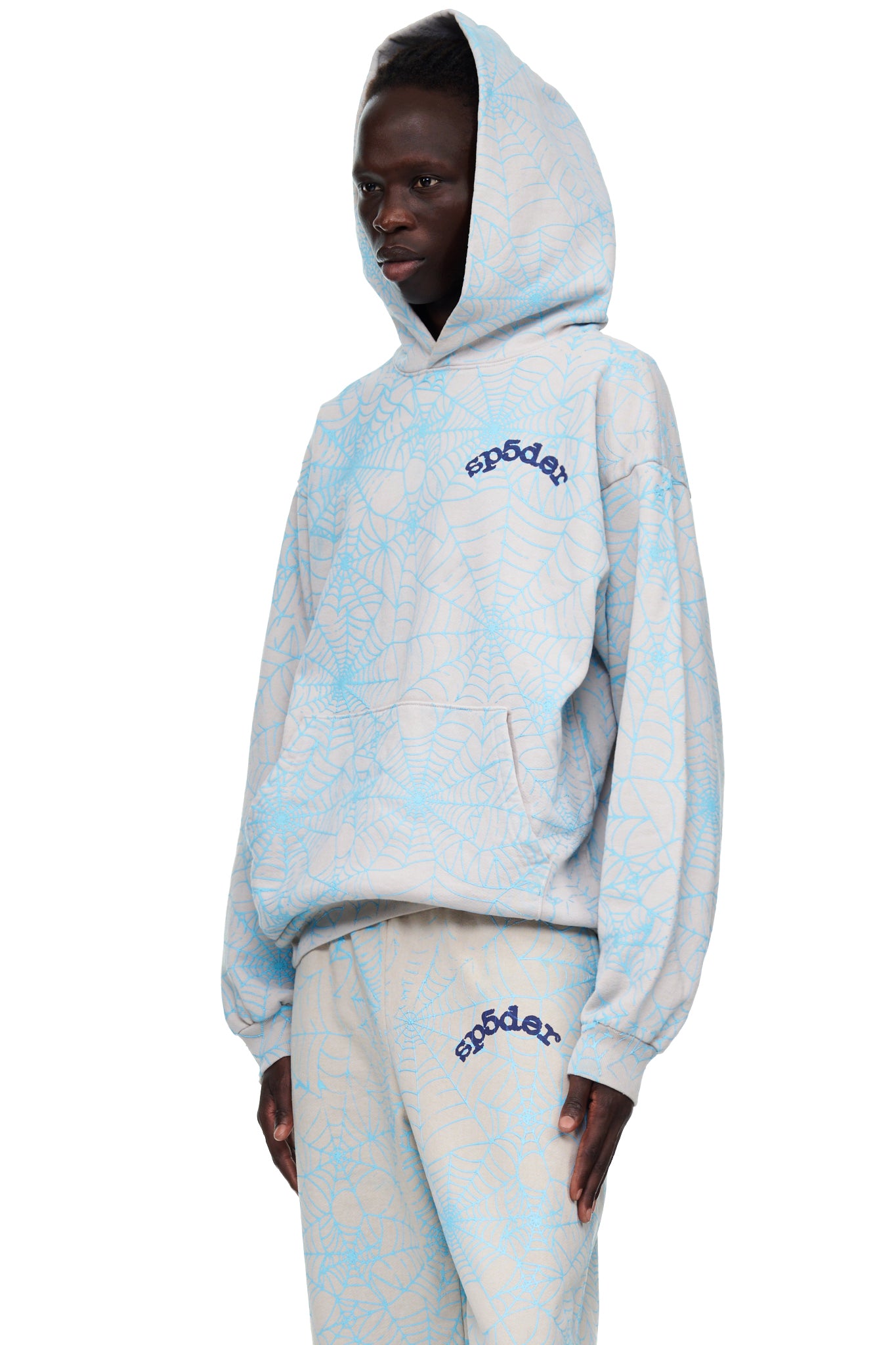 Beige fleece hoodie with all-over light blue cracked web print and "SP5DER" text.