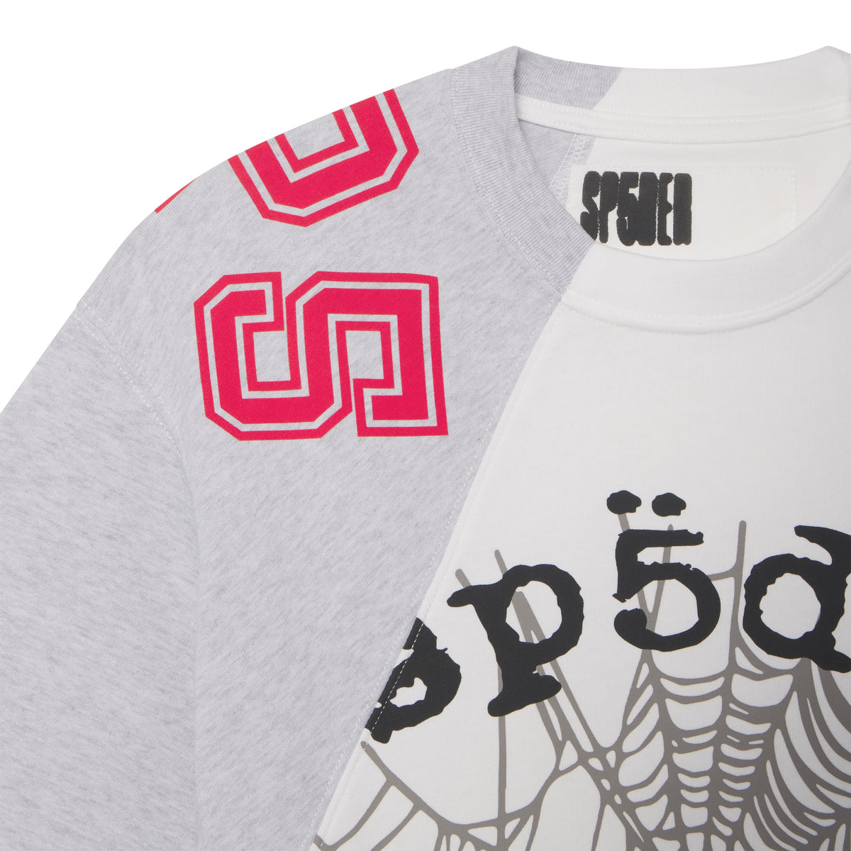 Asymmetrical cotton tee with color-block grey and white panels, collegiate red lettering, and a black web graphic print.