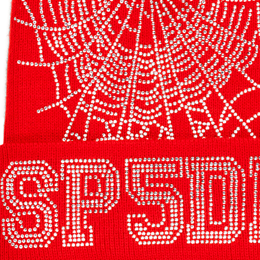 Red acrylic beanie with a rhinestone spider web and "SP5DER" logo design.