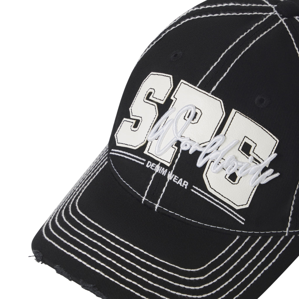Black denim baseball cap with white contrast stitching, layered SP5 logo appliqué, script embroidery, and a distressed curved brim.