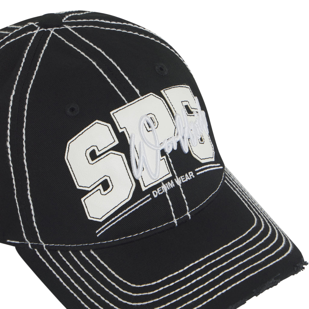 Black denim baseball cap with white contrast stitching, layered SP5 logo appliqué, script embroidery, and distressed brim.