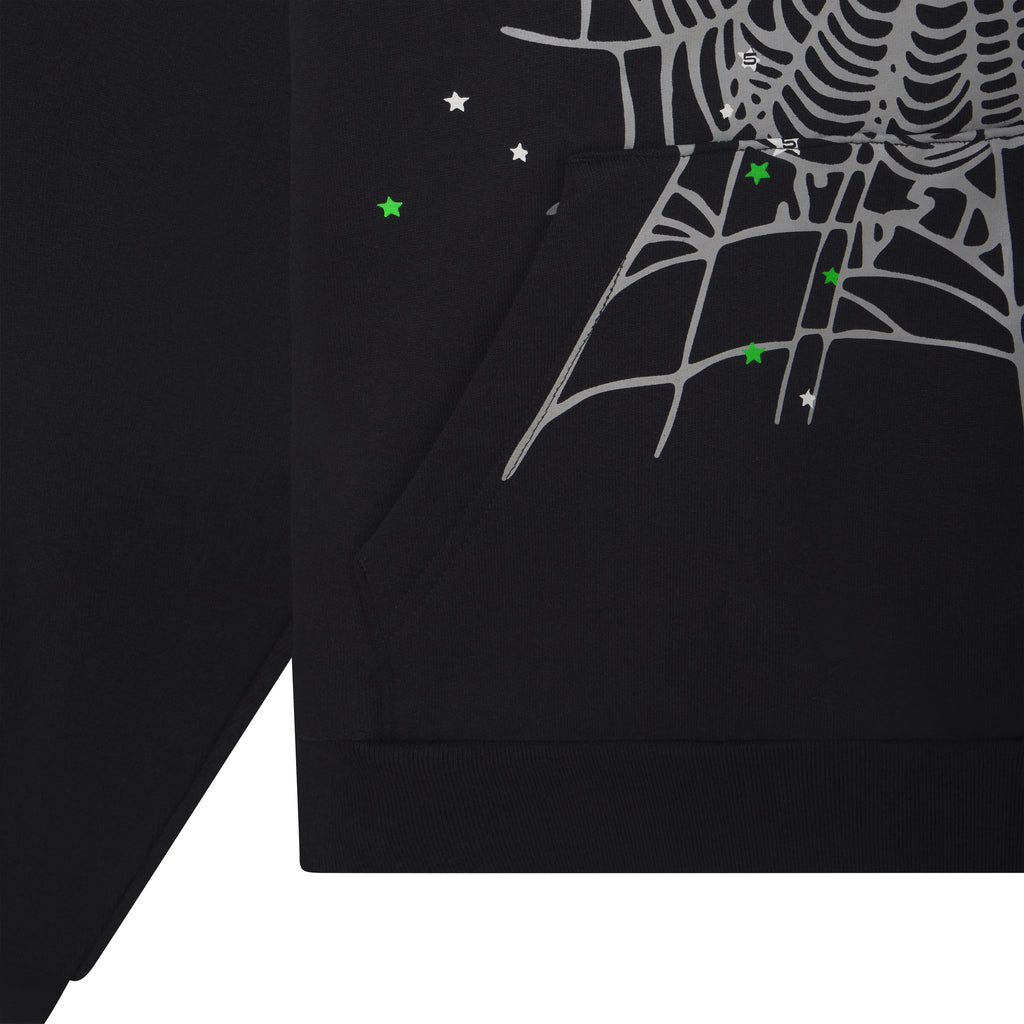 Black cotton fleece hoodie featuring a grey web graphic print, scattered tiny star details, and a front kangaroo pocket.