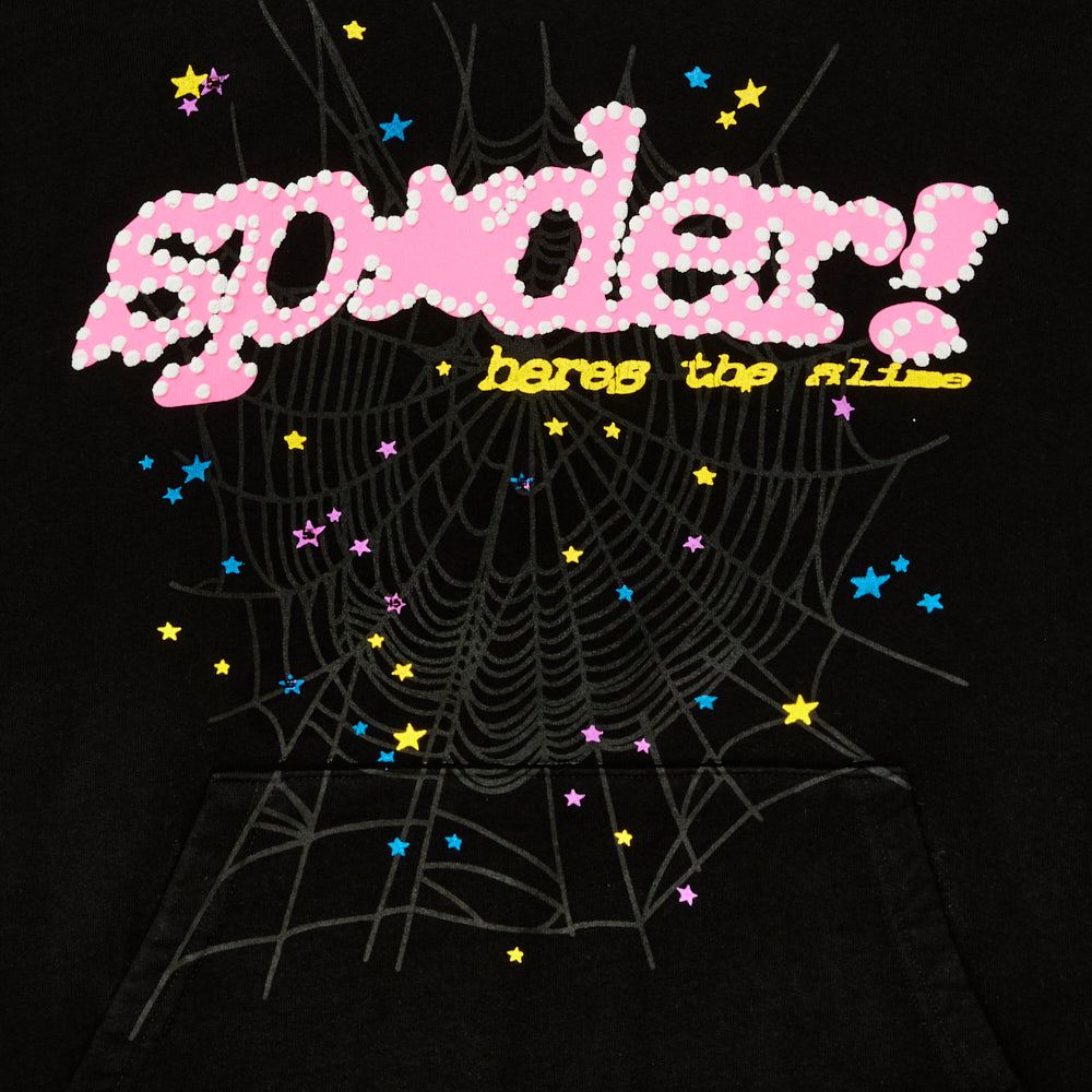 Black SP5DER V2 hoodie with pink puff print logo, "heres the slime" text, web, and colorful star prints.