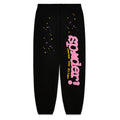Black fleece sweatpants with pink "SP5DER" puff print, yellow "heres the slime" discharge print, and scattered yellow and purple stars.
