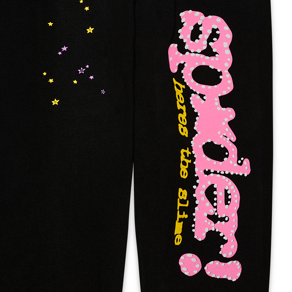 Black fleece sweatpant with pink "SP5DER" puff print, yellow "heres the slime" text, and scattered yellow and purple stars.
