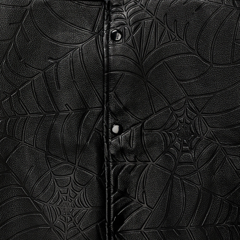 Black cowskin leather jacket with debossed spider web design and press-stud closure.